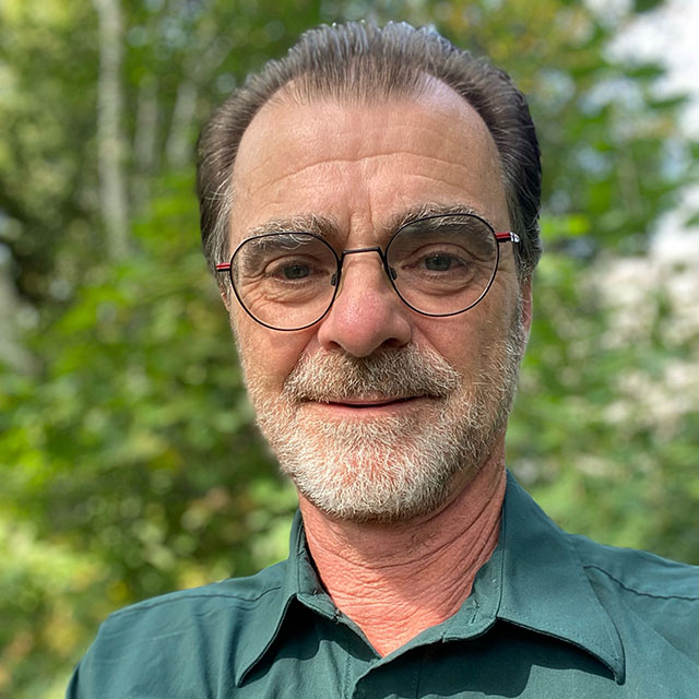 A headshot photo of Gilles Seutin in a Parks Canada uniform.