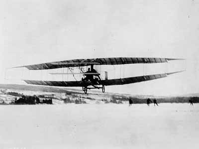 Flight of the Silver Dart aircraft of the Aerial Experimental Association, piloted by Douglas McCurdy. © Expired; Credit: Library and Archives Canada / PA-061741