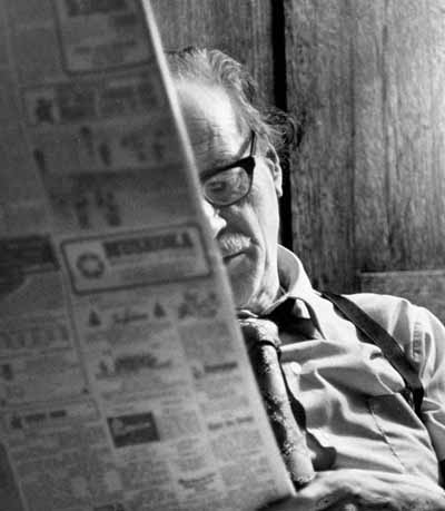 Marshall McLuhan reading newspaper © Expired; Credit: Louis Forsdale/Library and Archives Canada/PA-172801