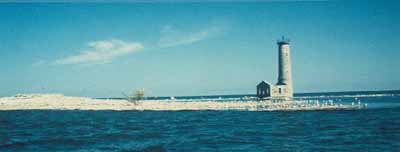 Corner view of the Lighthouse at Mohawk Island, showing the picturesque quality of its design and form, as seen in the height of the lighthouse in relation to the flat terrain of the island, 1987. © Department of the Environment / Ministère de l'Environnement, 1987.