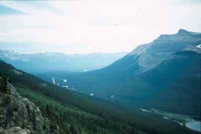 View of the final section of Kicking Horse Pass, showing the flanking mountains and the Spiral Tunnels, 1969. © Agence Parcs Canada / Parks Canada Agency, 1969.