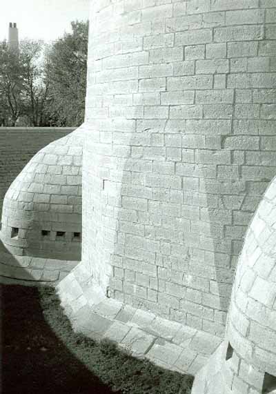 South side of Murney Martello Tower, showing the caponiers projecting into the ditch created by the encircling grassed berm, 1991. © Parks Canada Agency / Agence Parcs Canada, Fern Graham, 1991.