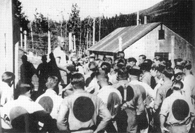 Prisoners of war at Camp 133, Lethbridge, Alberta. All prisoners had large red circles on the backs of their clothing and a red stripe down the pant leg © Fooks, Prairie Prisoners, 60