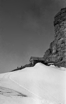 General view of Abbot Pass Refuge Cabin, showing its simple massing as one-and-a-half-storey rectangle under a pitched roof, 1930. © Parks Canada Agency / Agence Parcs Canada, 1930.