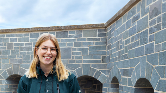 A young Parks Canada employee who smiles.